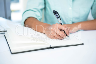 Close up view of a businesswoman writing notes