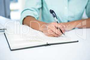 Close up view of a businesswoman writing notes