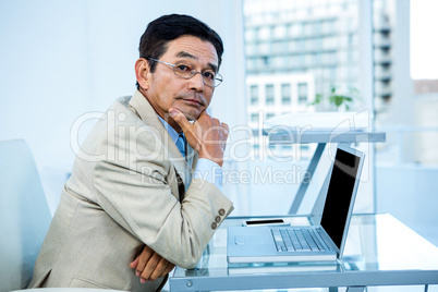 Thoughtful businessman looking at the camera