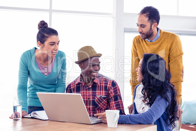 Happy business people discussing at creative office