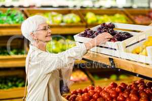 Senior woman holding bag with apple