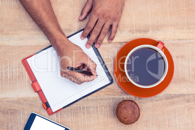 Man writing on diary