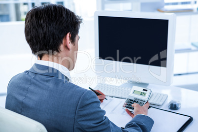 Businessman using his calculator