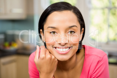 Portrait of smiling brunette in kitchen