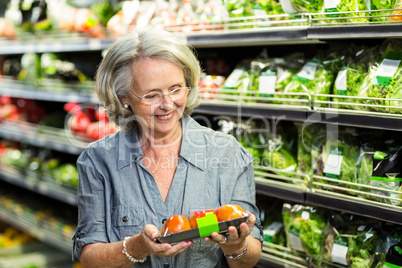 Senior woman picking out some vegetables