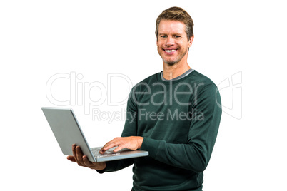 Portrait of smiling man using laptop