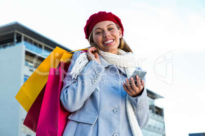 Girl using at her phone during shopping