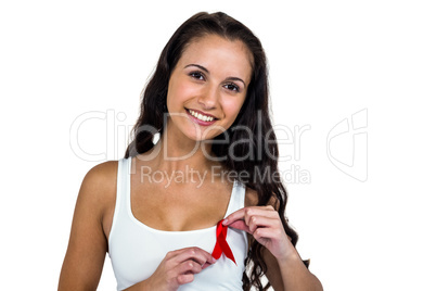 Portrait of smiling woman adjusting red ribbon