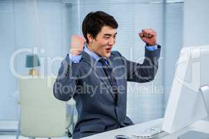 Businessman,celebrating with arms up