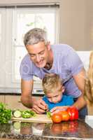 Happy family slicing vegetables