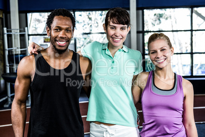 Muscular smiling people standing together