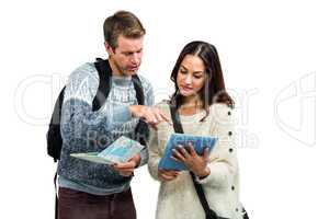 Couple with map and digital tablet while traveling