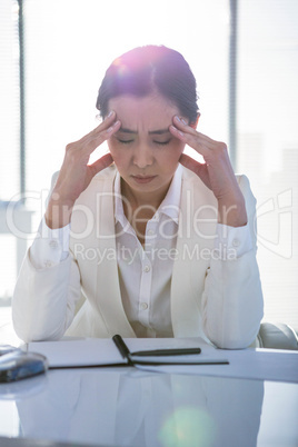 Stressed businesswoman working at her desk