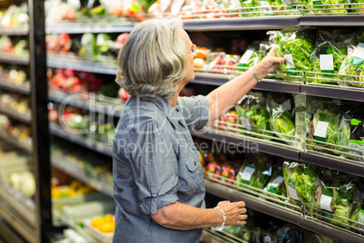 Senior woman picking out some vegetables