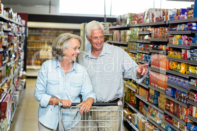 Smiling senior couple buying food