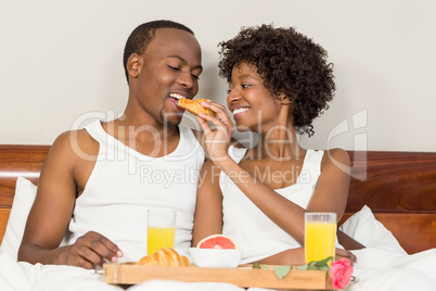 Happy family lying in bed together