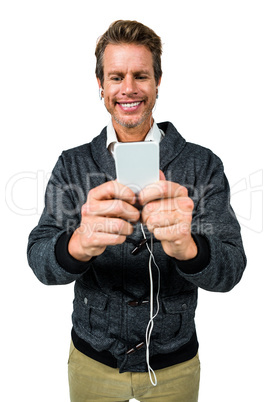 Happy man listening music while using mobile phone