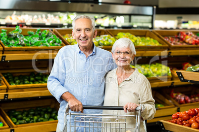 Happy senior couple with cart Happy senior couple with cart