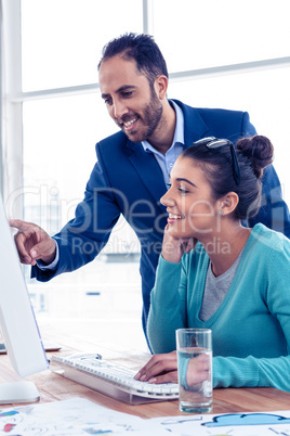 Happy businessman explaining to coworker