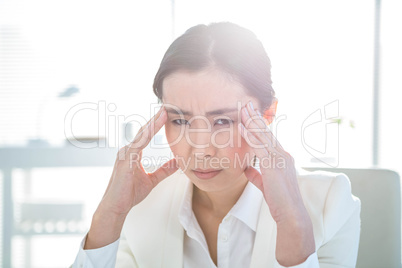 Stressed businesswoman working at her desk