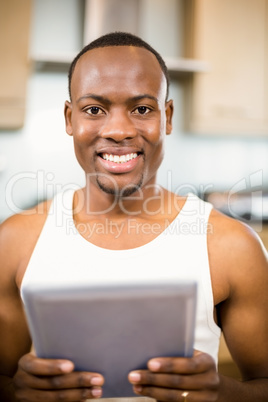 Smiling man holding tablet