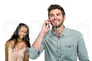Smiling couple using cellphones