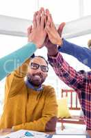 Business man doing high five with team in creative office