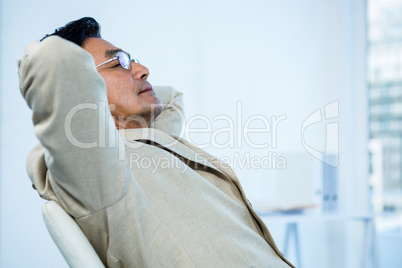 Smiling asian businessman stretching