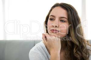 Woman thinking with hand on chin