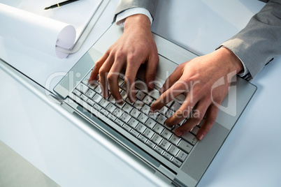 Close up view of businessman using laptop computer