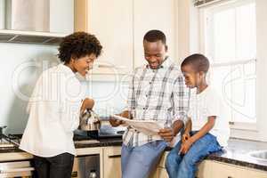 Family reading in the kitchen