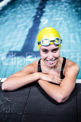 Swimmer woman lean on the edge of the swimming pool