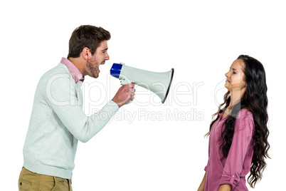 Screaming man holding loudspeaker with girlfriend