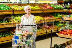 Senior woman putting banana in her trolley