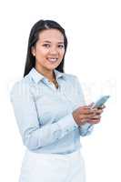 Smiling businesswoman using her smartphone