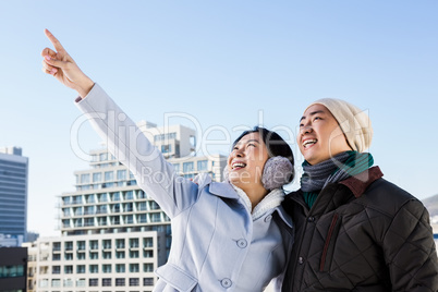 Happy woman pointing finger with boyfriend