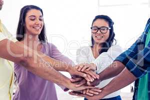 Businesswomen stacking hands with team
