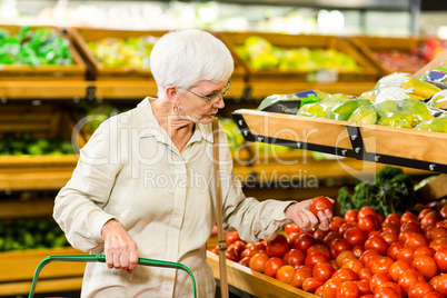 Senior woman picking out some vegetables