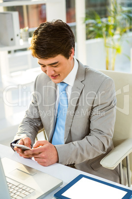 Happy businessman using his phone Happy businessman using his phone