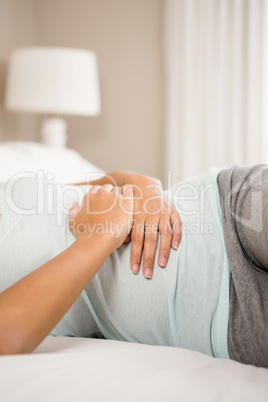 Mid section of woman with hands on stomach