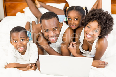 Happy family lying on the bed