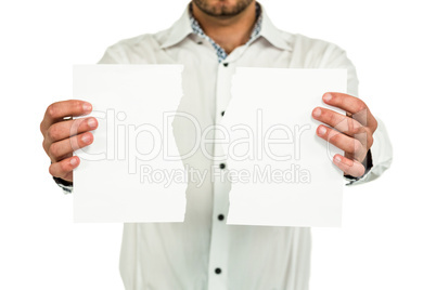 Standing man showing torn papers