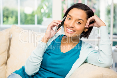 Smiling brunette on a phone call