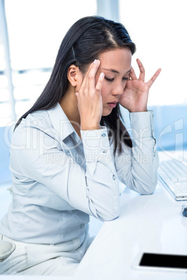 Thoughtful businesswoman with hands on face