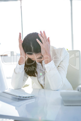 Stressed businesswoman working at her desk