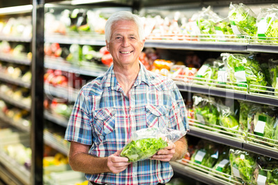 Senior man picking out salad