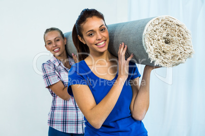 Friends holding a carpet