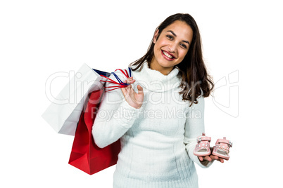 Portrait of happy woman with shopping bags and footwear