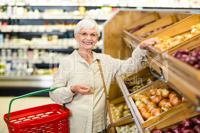 Senior woman picking out some vegetables