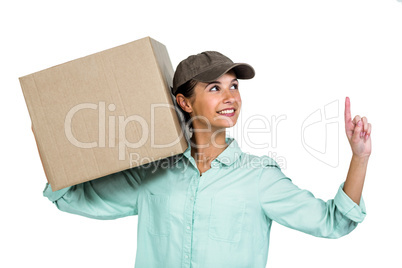 Happy delivery woman holding box pointing up